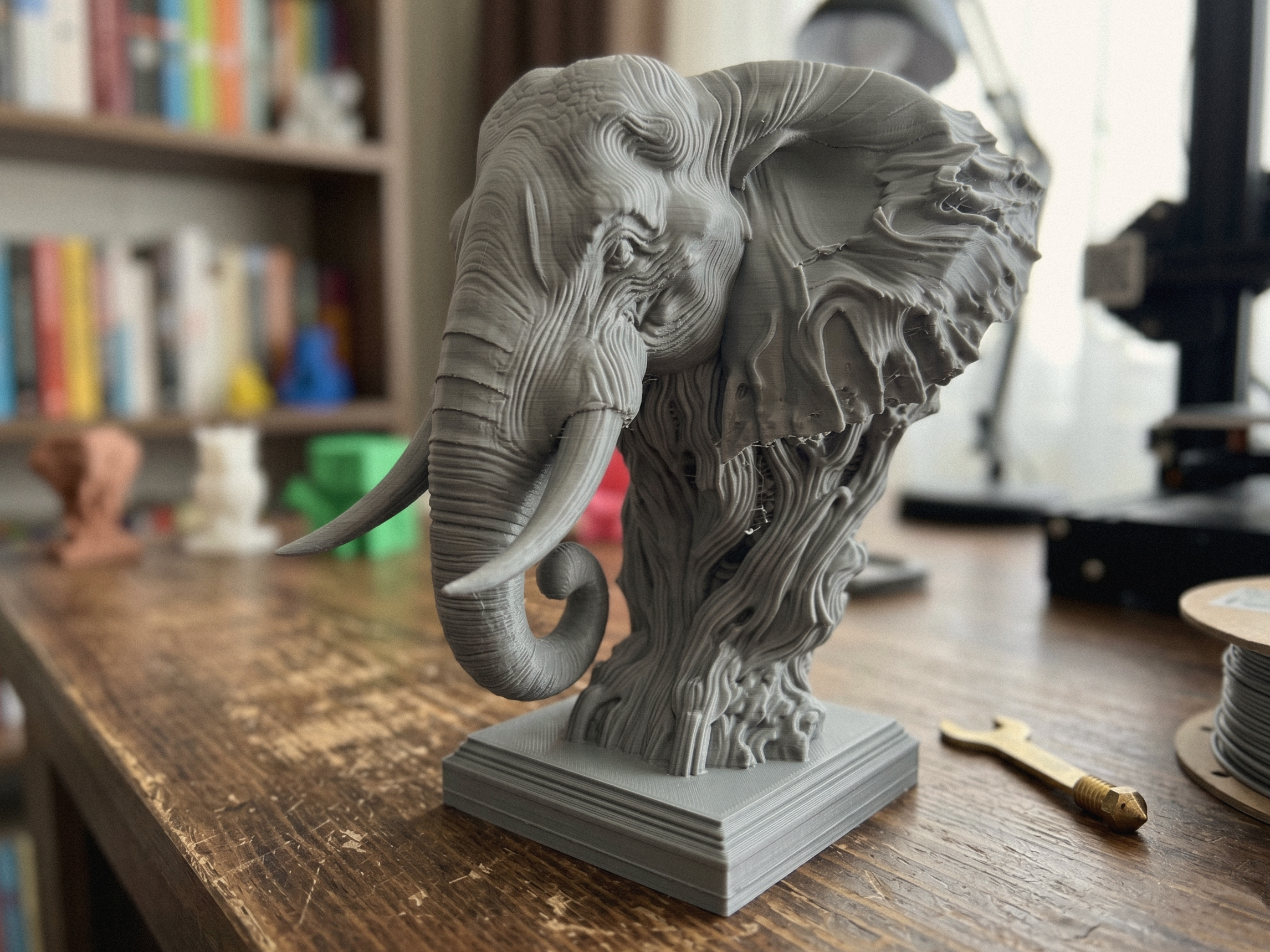 Sculpture buste d’éléphant ancien sur socle, détail du visage et de la trompe.